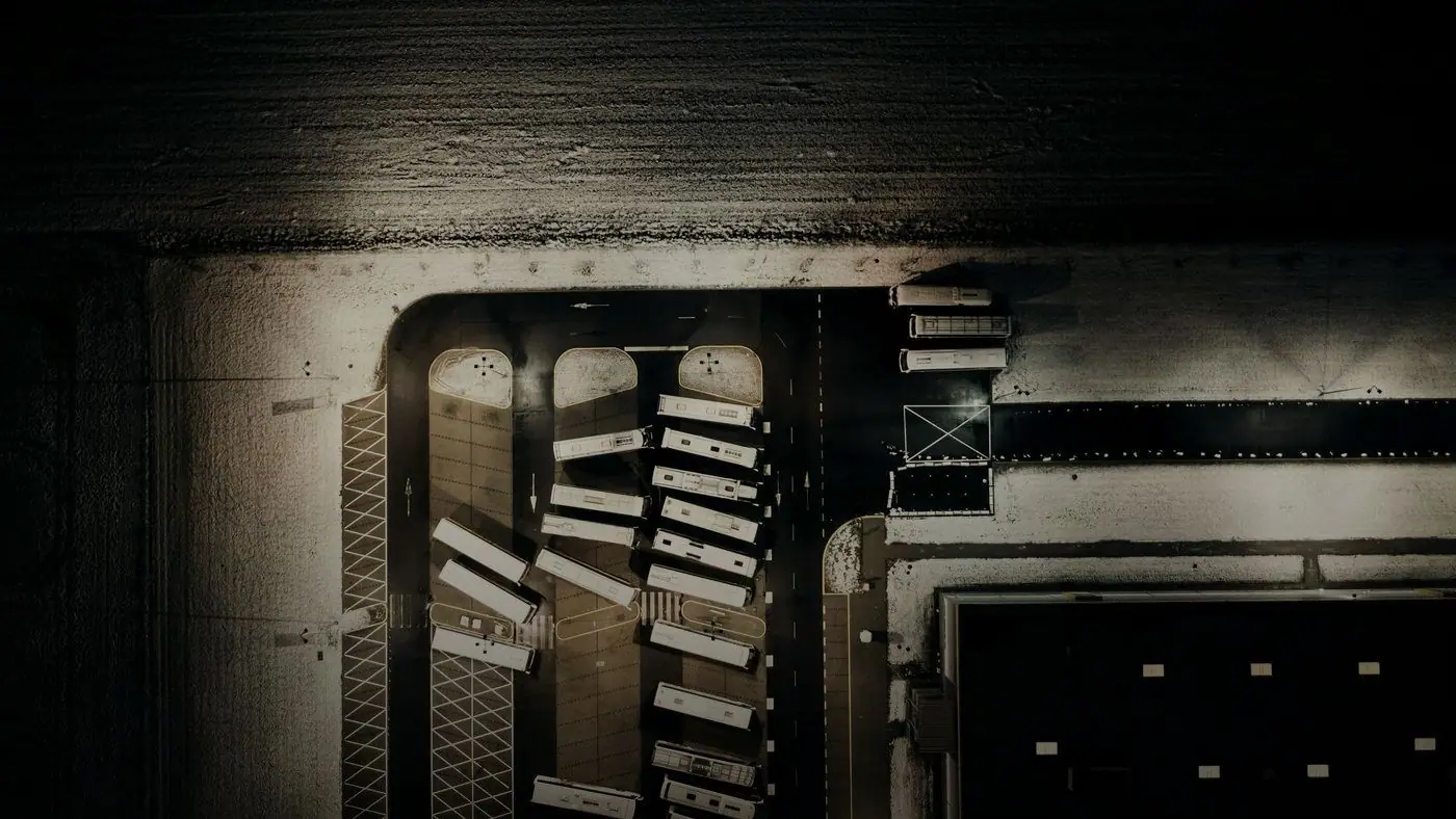 Overhead view of a lit industrial building at night