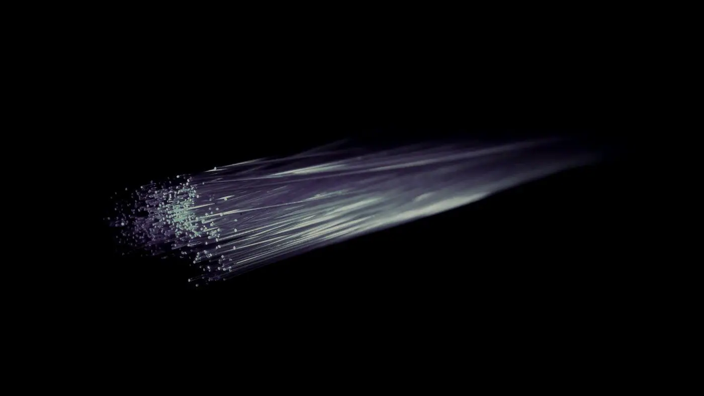 Fibre optic strands fanning out in the dark